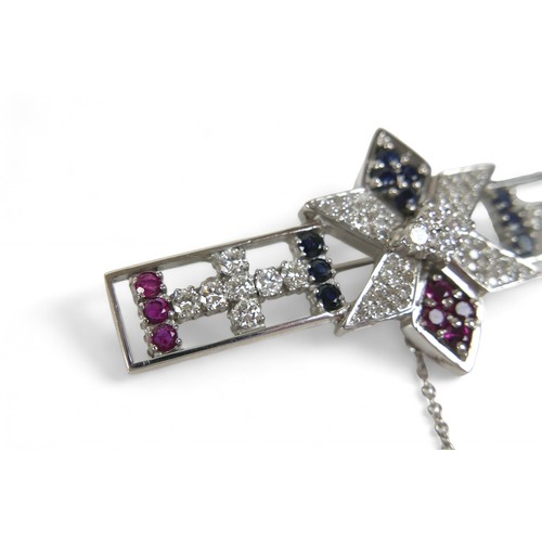 54 - A sapphire, ruby and diamond set 18ct white gold brooch, comprising a open bar form with six sided s... 