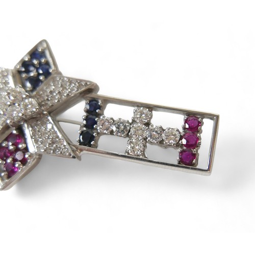 54 - A sapphire, ruby and diamond set 18ct white gold brooch, comprising a open bar form with six sided s... 