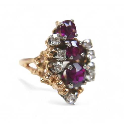 48 - A 14ct gold diamond and ruby cluster ring, featuring eight round cut diamonds and three graduated ru... 