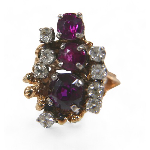 48 - A 14ct gold diamond and ruby cluster ring, featuring eight round cut diamonds and three graduated ru... 