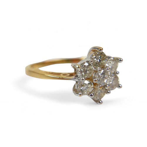 8 - An 18ct yellow gold and diamond ring, the seven round cut diamonds set in a flower head pattern, cen... 