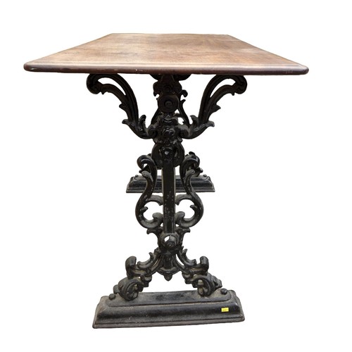 334 - A cast iron pub table with a mahogany top, 112 by 57 by 74cm.