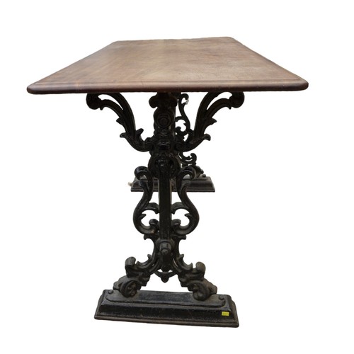 334 - A cast iron pub table with a mahogany top, 112 by 57 by 74cm.