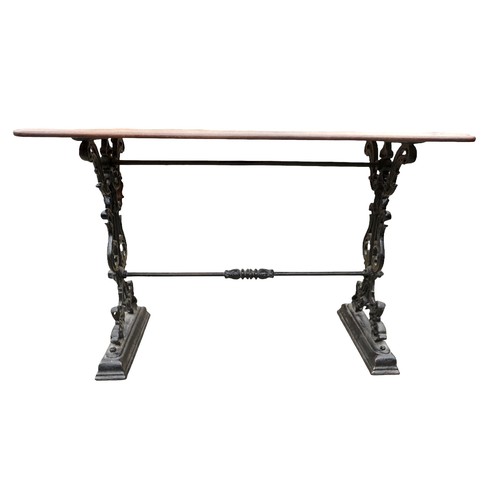 334 - A cast iron pub table with a mahogany top, 112 by 57 by 74cm.