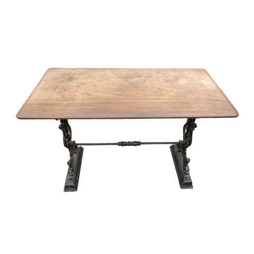 334 - A cast iron pub table with a mahogany top, 112 by 57 by 74cm.