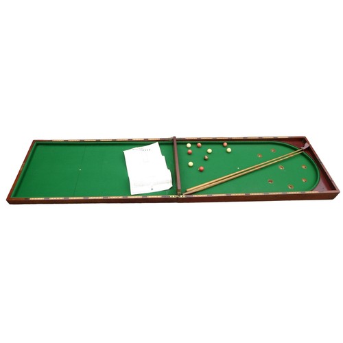 243 - A Victorian mahogany table top bagatelle game with cue and rules, 244 by 63 by 6cm high open.