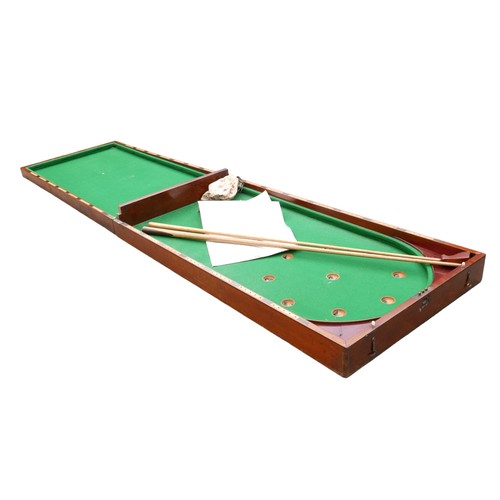 243 - A Victorian mahogany table top bagatelle game with cue and rules, 244 by 63 by 6cm high open.