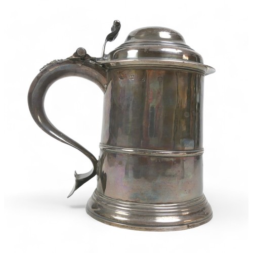 85 - A George II silver lidded tankard, domed cover, scroll thumbpiece, skirted base, engraved to handle,... 