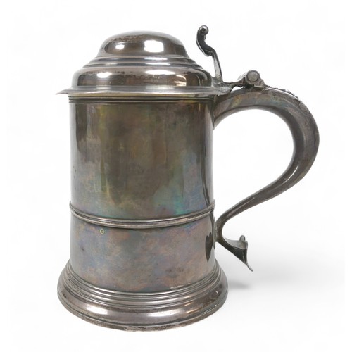 85 - A George II silver lidded tankard, domed cover, scroll thumbpiece, skirted base, engraved to handle,... 