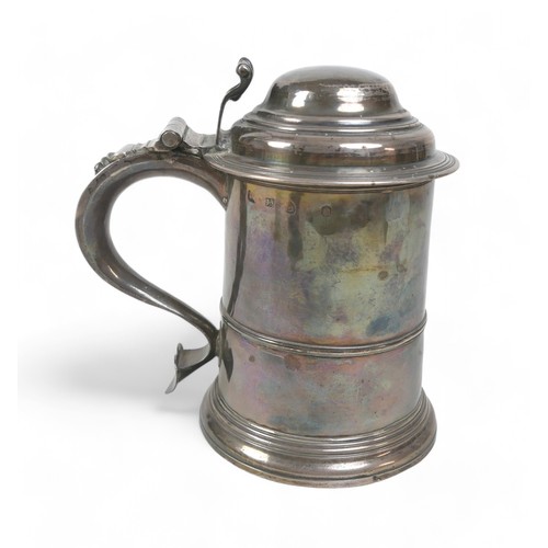 85 - A George II silver lidded tankard, domed cover, scroll thumbpiece, skirted base, engraved to handle,... 