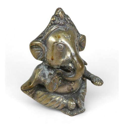 199 - A 20th century Indian Hindu bronze figure depicting the elephant god Ganesha, 10 by 8 by11cm high.