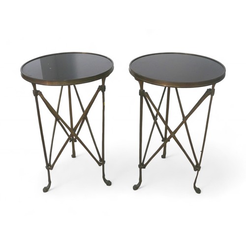 352 - A pair of Gueridon style Neoclassical black stone and brass side tables, each raised on three-legs w... 