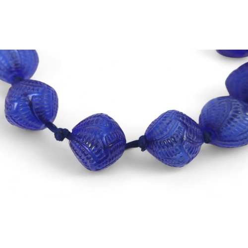 49 - A René Lalique Lotus blue glass necklace, with twelve beads, 25.4 by 24.2mm, 42cm long, together wit... 