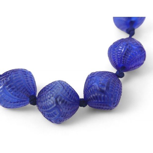 49 - A René Lalique Lotus blue glass necklace, with twelve beads, 25.4 by 24.2mm, 42cm long, together wit... 