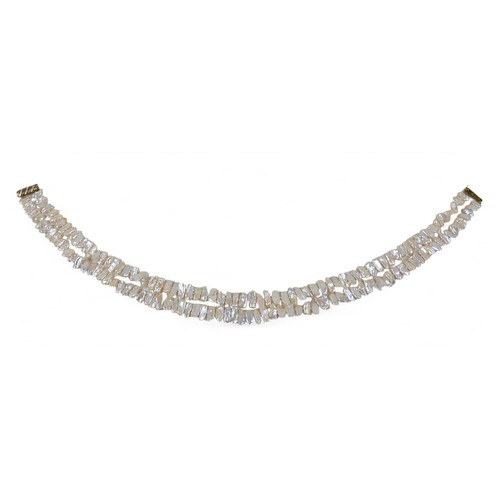 33 - A double strand baroque pearl necklace, the strands having 77 and 72 pearls are joined by a 9ct gold... 