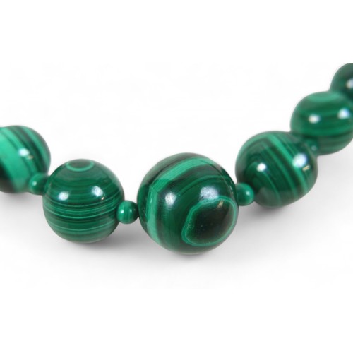 14 - A malachite bead necklace, formed of 46 graduating beads, separated by 48 smaller beads, with 9ct go... 