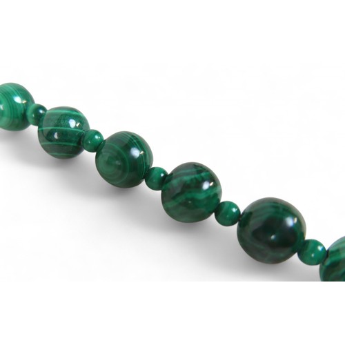 14 - A malachite bead necklace, formed of 46 graduating beads, separated by 48 smaller beads, with 9ct go... 