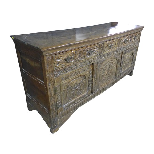 357 - An antique carved oak dresser base, dated 1675 with three frieze drawers above two cupboard doors an... 