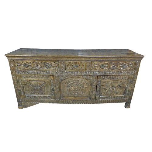 357 - An antique carved oak dresser base, dated 1675 with three frieze drawers above two cupboard doors an... 