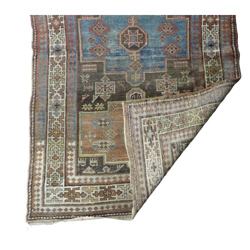 359 - A long woolen hand knotted runner rug, with stylised triple border, 466 by 107cm.