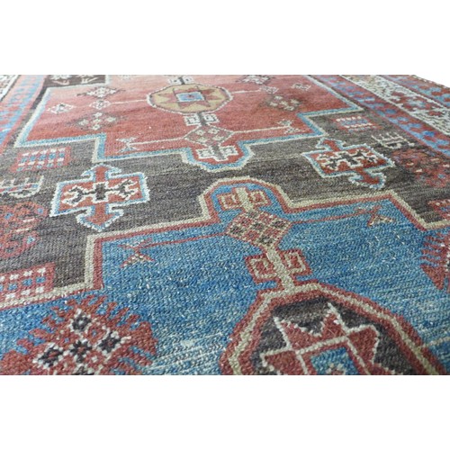 359 - A long woolen hand knotted runner rug, with stylised triple border, 466 by 107cm.