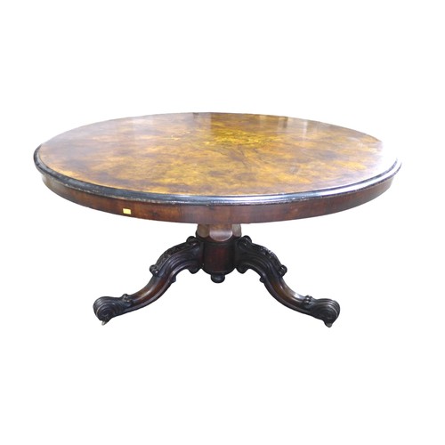 349 - A Victorian burr walnut circular breakfast table, on a carved tripod base terminating on scroll ends... 