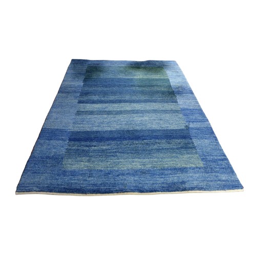 362 - A Gabbeh rug with a blue border and a blue central rectangle, 242 by 186cm.