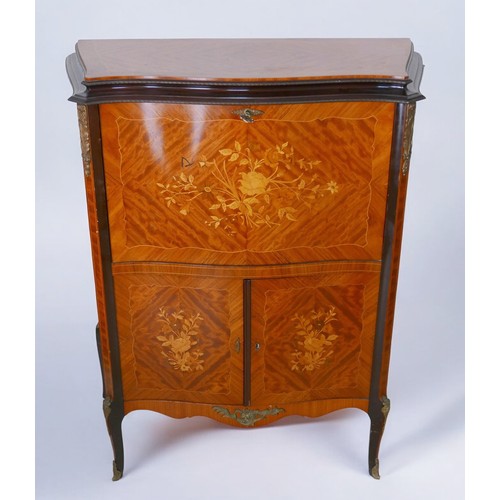 368 - A 1950s walnut cocktail cabinet, in French 18th century style, with peach glass liner, mirrored inte... 