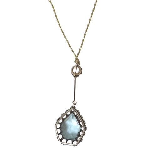 60 - A white sapphire and pale blue topaz pendant, on unmarked gold mounts, testing as at least 9ct gold,... 