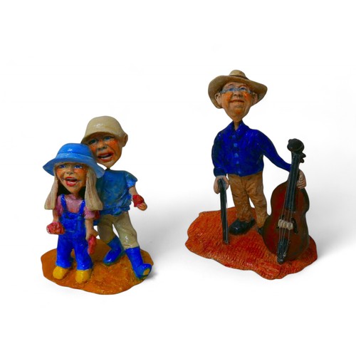 197A - A pair of Dorienne Carmel contemporary stylised figurines, hand painted ceramic, comprising a cello ... 