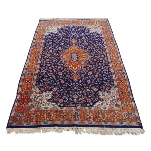 338 - A woolen rug with a blue field and stylised border, 128 by 200cm.