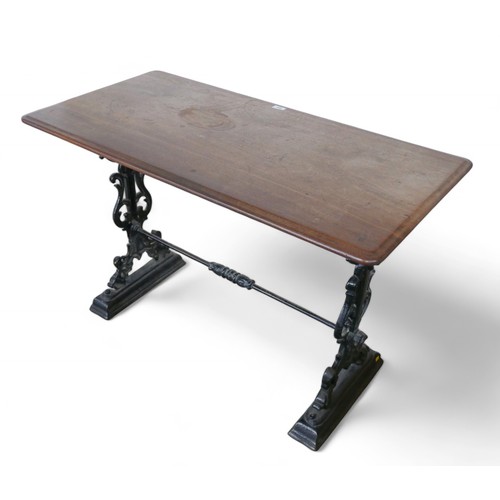 301 - A cast iron pub table with a mahogany top, 112 by 57 by 74cm.