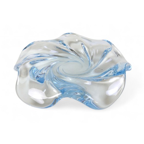 134 - A Swedish art glass low bowl by Edvin Ohrstrom, the tinted blue glass moulded in a swirl design, sig... 