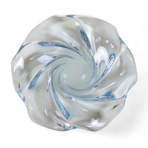 134 - A Swedish art glass low bowl by Edvin Ohrstrom, the tinted blue glass moulded in a swirl design, sig... 