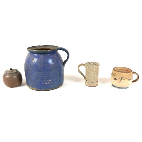 137 - A collection of four pottery items, comprising a blue glazed jug with handle, 17 by 16.5cm high, a s... 