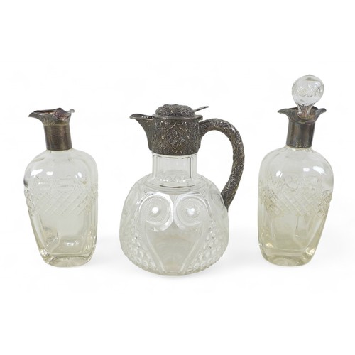 95 - A cut glass silver top claret jug and two silver rim decanters, the claret jug Drew and sons London ... 