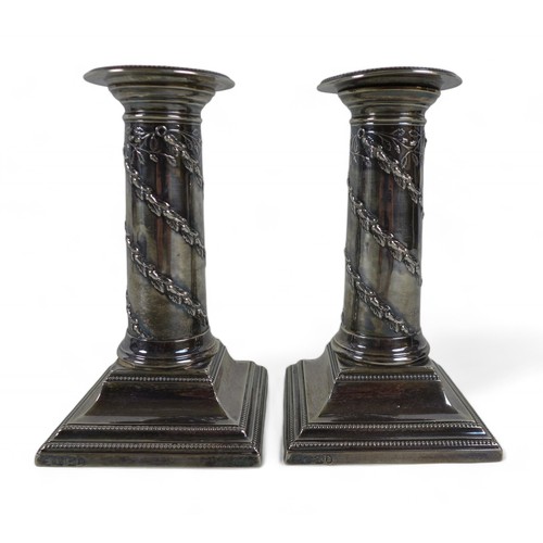 96 - A pair of Victorian weighted silver candlestick, a capstan inkwell and a boxed set of silver handle ... 