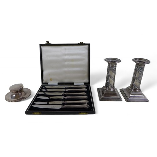 96 - A pair of Victorian weighted silver candlestick, a capstan inkwell and a boxed set of silver handle ... 