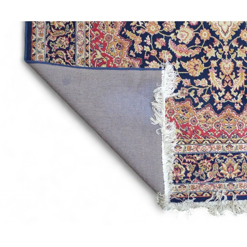 322 - Two modern machine made rugs, blue ground rug, 280 by 200cm, red ground rug, 160 by 228cm.