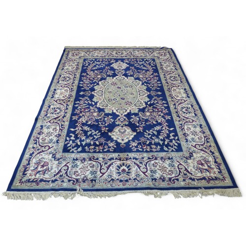 322 - Two modern machine made rugs, blue ground rug, 280 by 200cm, red ground rug, 160 by 228cm.