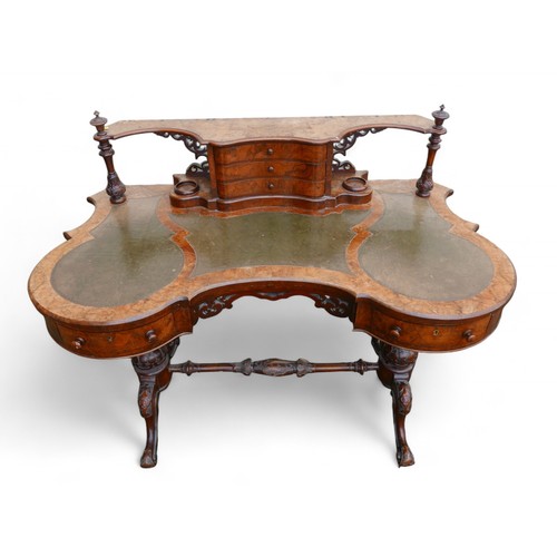 343 - A Victorian burr walnut writing table, with a serpentine three drawer upstand on a shaped leather in... 