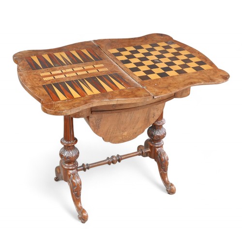 339 - A Victorian burr walnut games/work table, with a fold over games board top above a basket on carved ... 