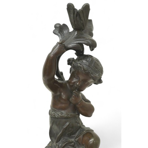 170 - A bronze figure of a putti on a rocky outcrop on marble base, 20 by 15 by 45cm high.