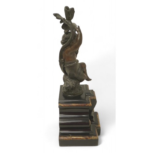 170 - A bronze figure of a putti on a rocky outcrop on marble base, 20 by 15 by 45cm high.