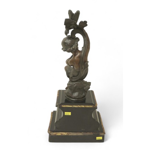 170 - A bronze figure of a putti on a rocky outcrop on marble base, 20 by 15 by 45cm high.