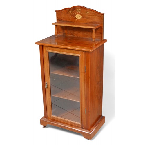 313 - An early 20th century mahogany music cabinet, with single glazed door, 56 by 34.5 by 120.5cm high.