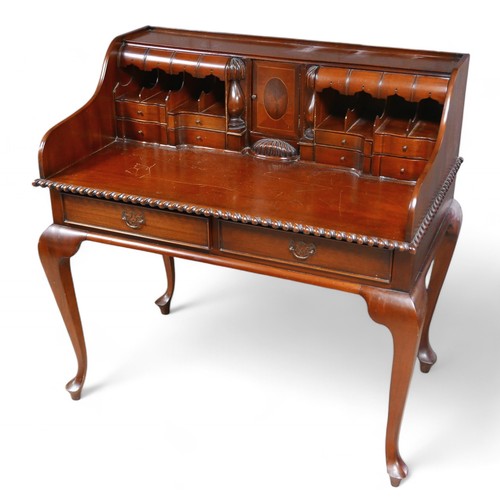 315 - A Chippendale style mahogany desk, with cubby holes, letter racks, drawers to its galleried top, rai... 