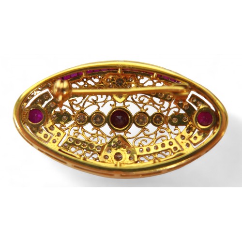 3 - An 18ct gold diamond and ruby oval form brooch, with round cut diamonds and rubies central round cut... 