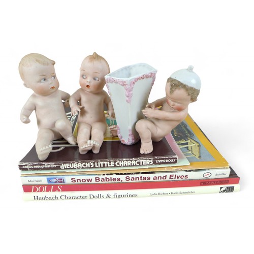 148 - Three bisque porcelain upright position figures with reference books, comprising two Heubach figures... 