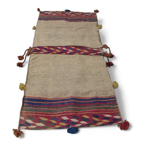 334 - A Kelim double pocket camel rug, 180 by 80cm.